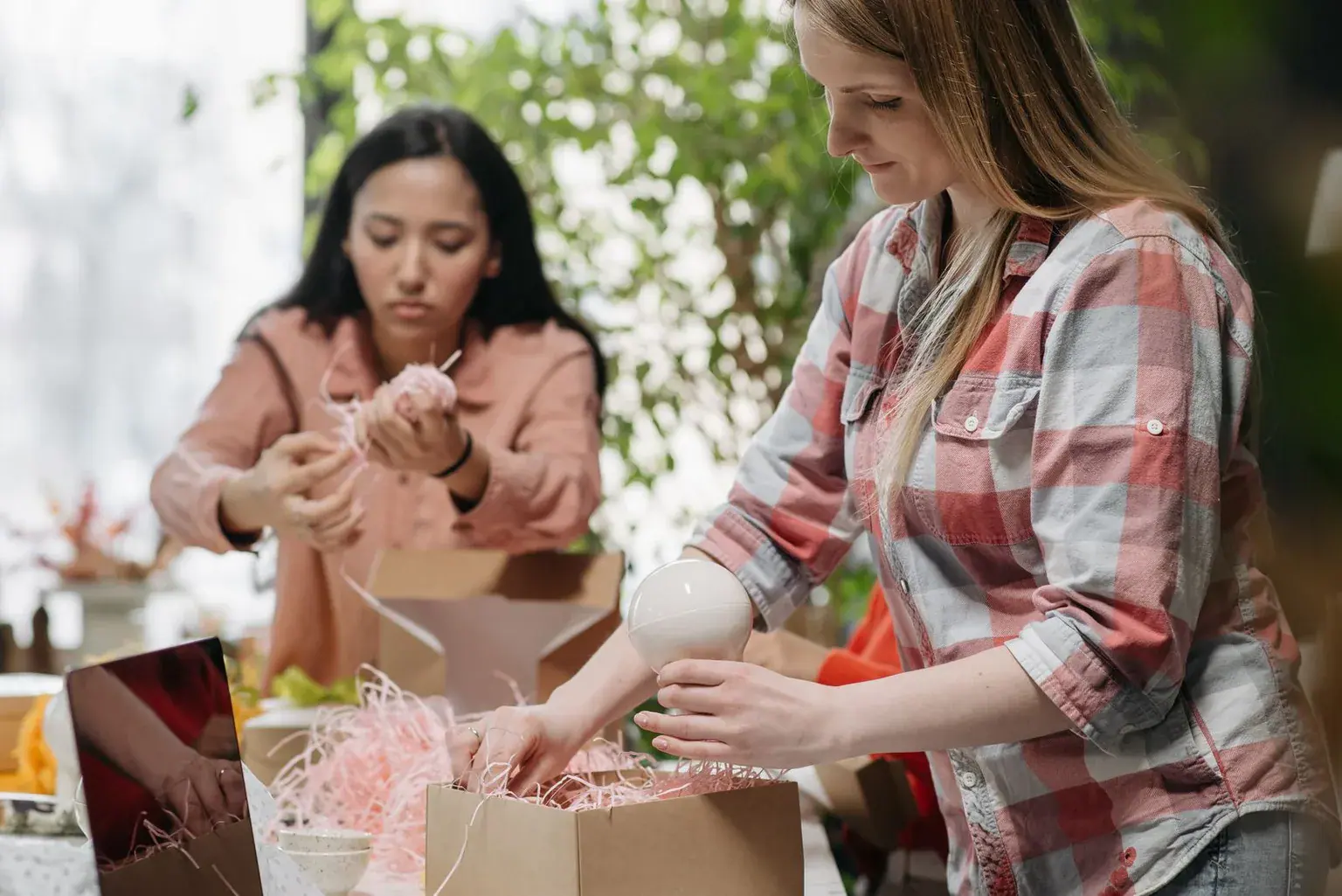 Two business owners carefully packing customer orders